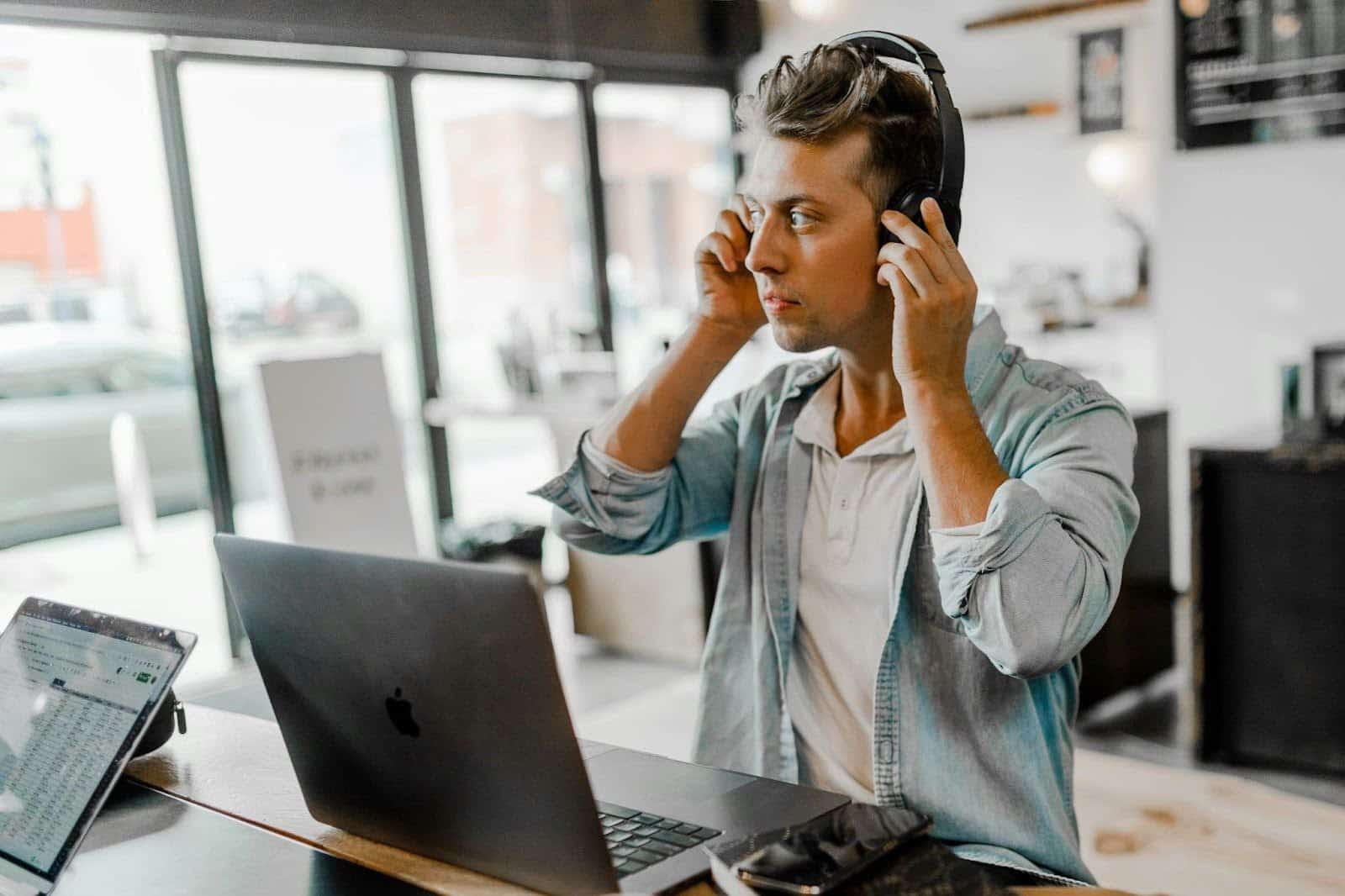 A man wearing noise-canceling headphones, focused and undisturbed.