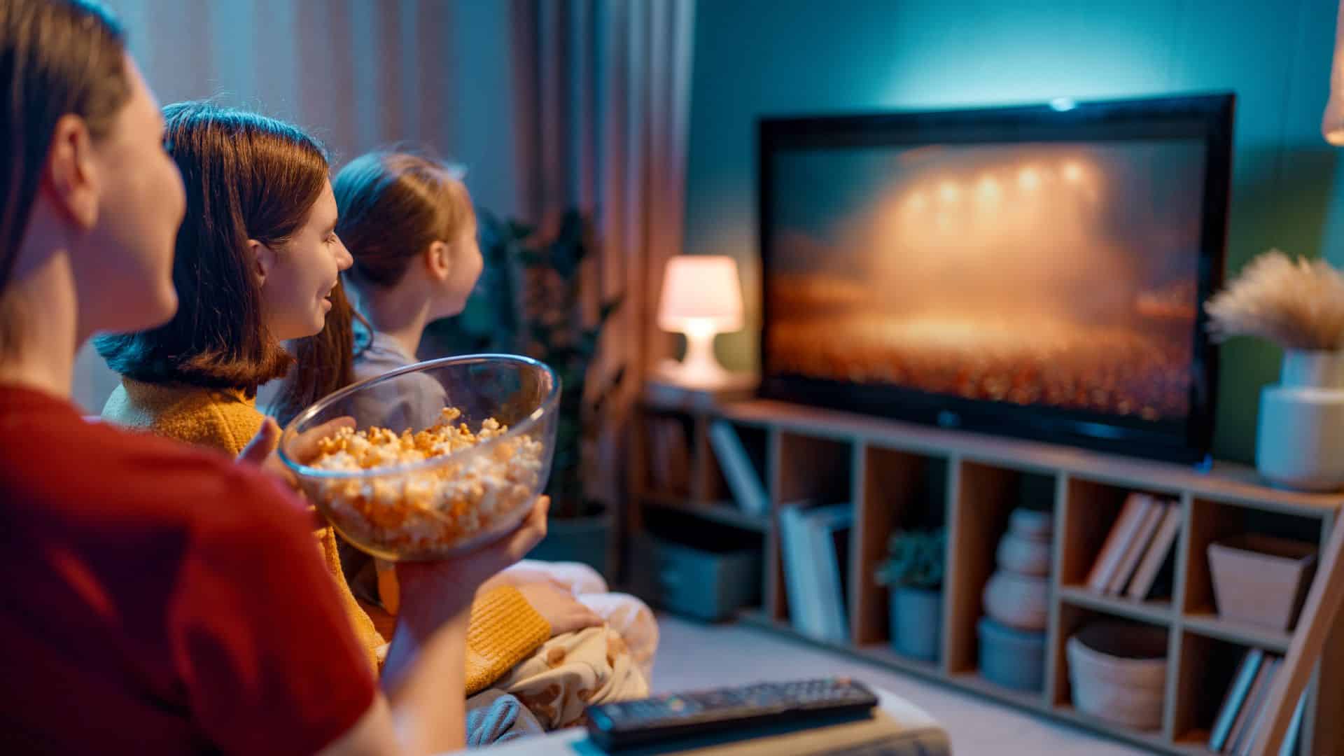 A group of friends chilling on the couch enjoying the oscars 2026 watch party.