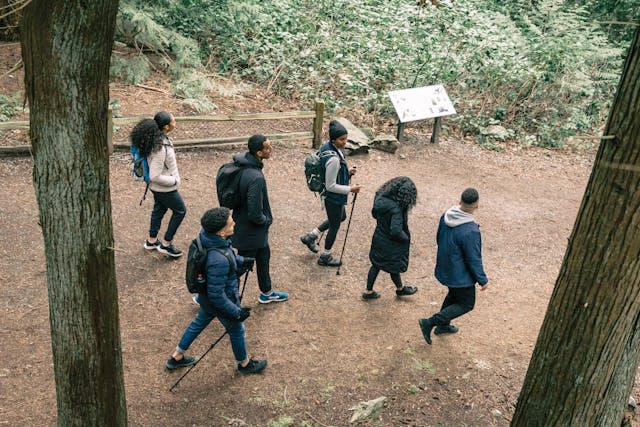 People hiking in forest analog living low tech lifestyle nature routine