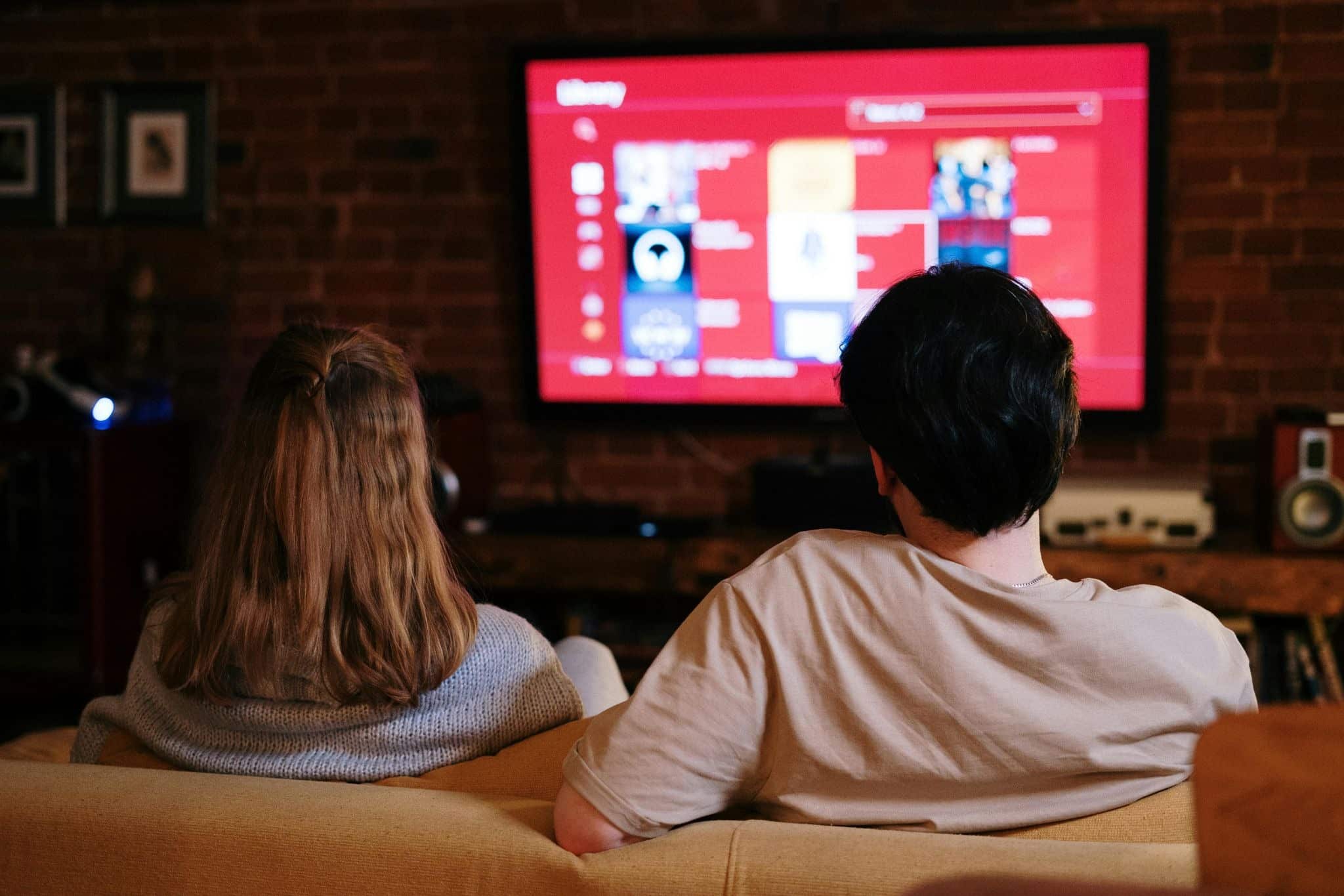 Passive Screen Time and Dementia Risk shown by couple watching TV while distracted on phone