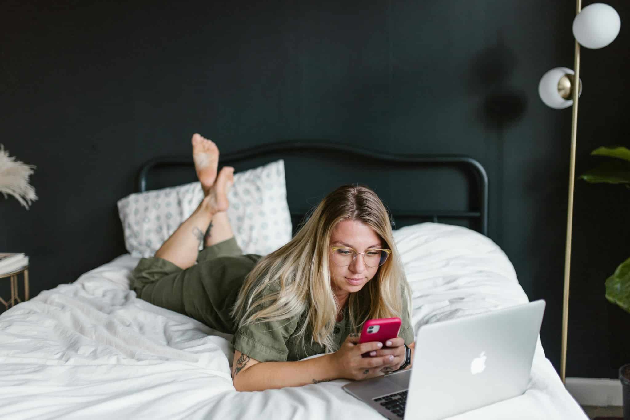 female on phone in bed